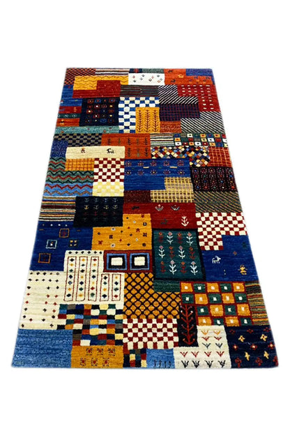 Gabbeh rug, laid flat, with colorful geometric blocks and ornamental inserts