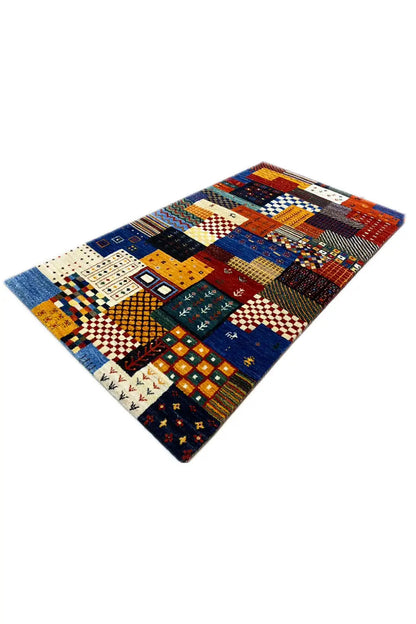 Gabbeh rug with diagonal rows of patchwork patterns, predominantly blue and orange