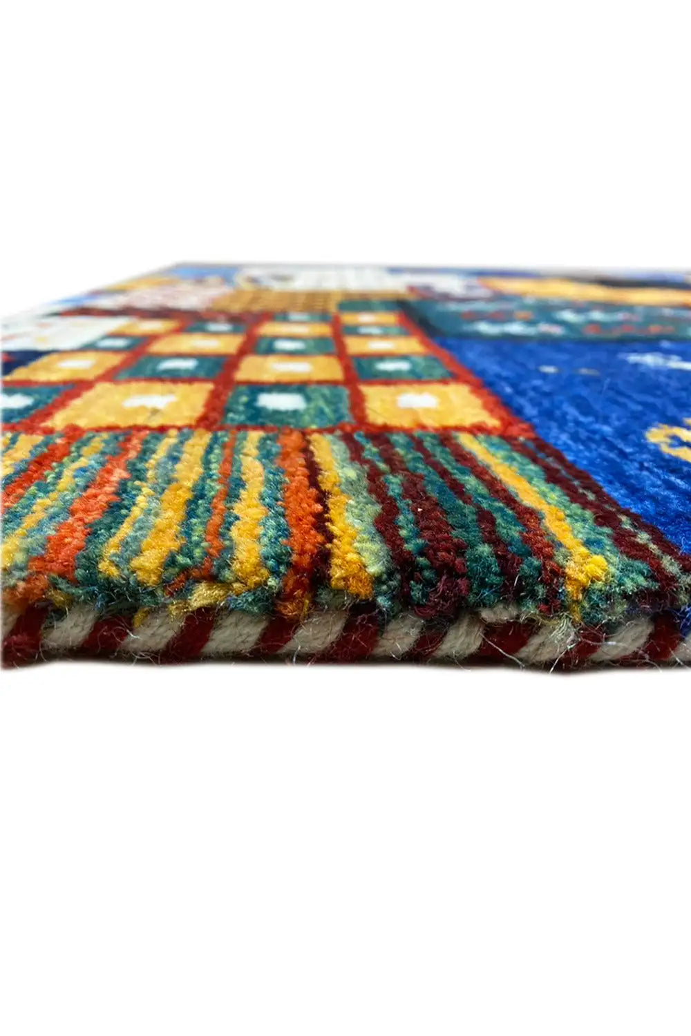 Gabbeh rug detail with short pile at the edge and colorful block patterns