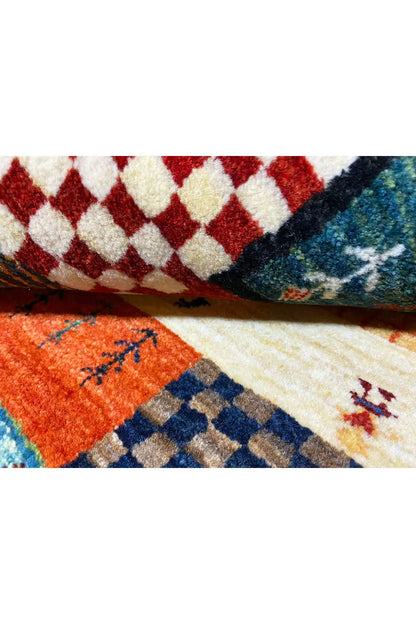 Gabbeh rug detail: bordered tile patterns with a color gradient and multicolored pile