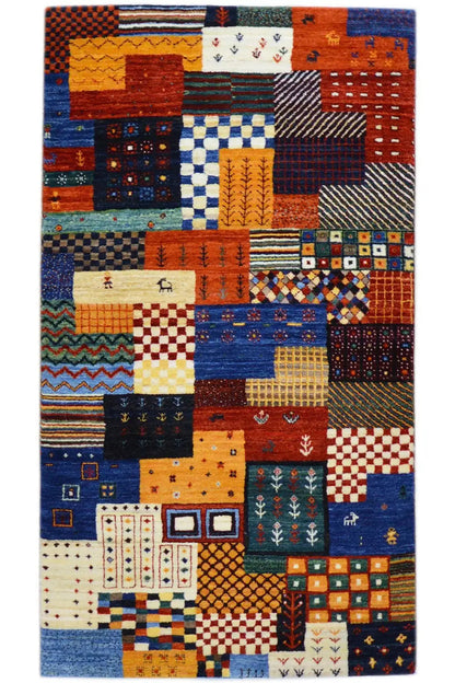 Gabbeh rug with colorful patchwork of geometric patterns in blue, orange, and red