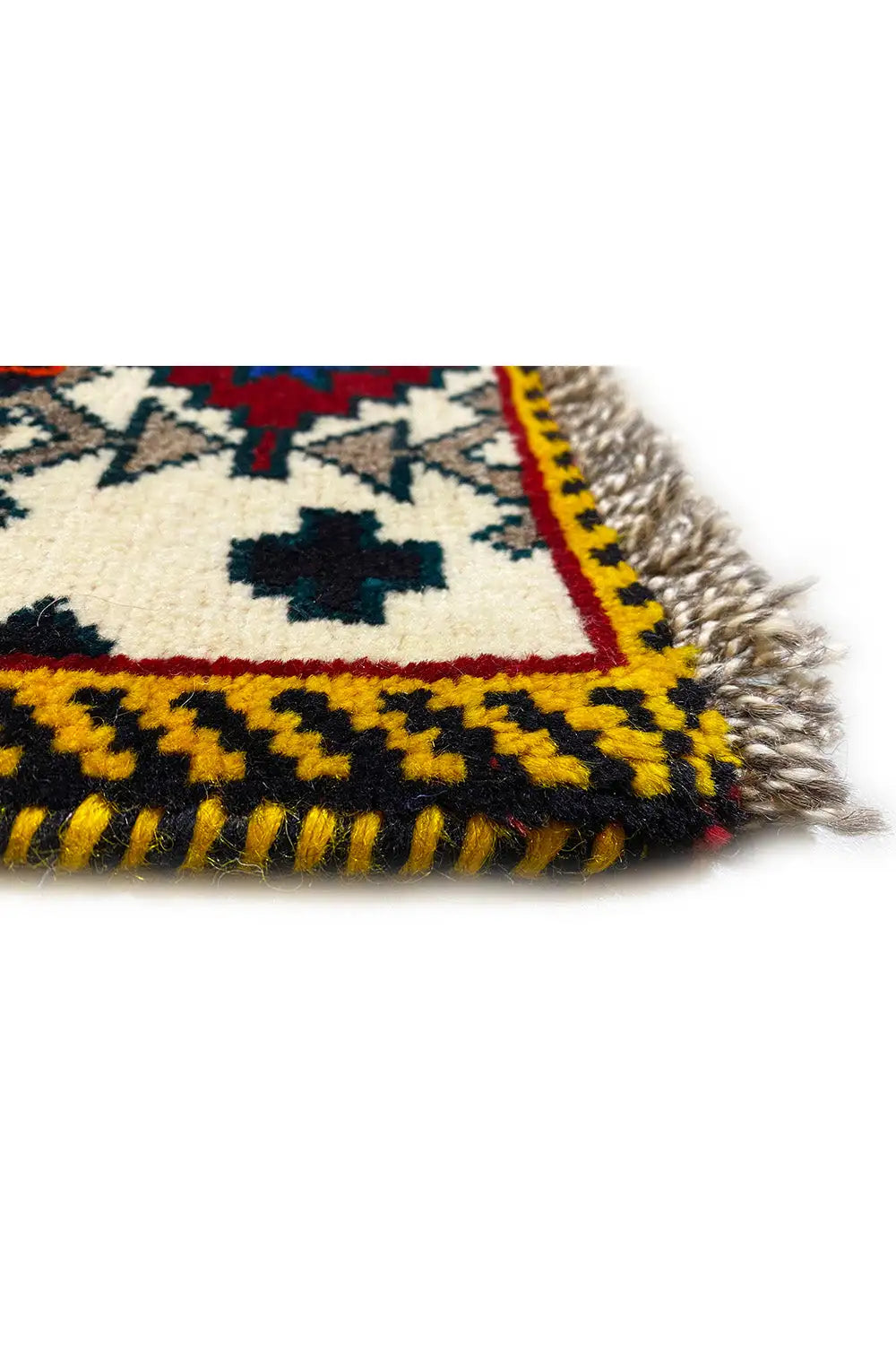 Gabbeh rug corner with fringe and patterned border, multicolored with a light background