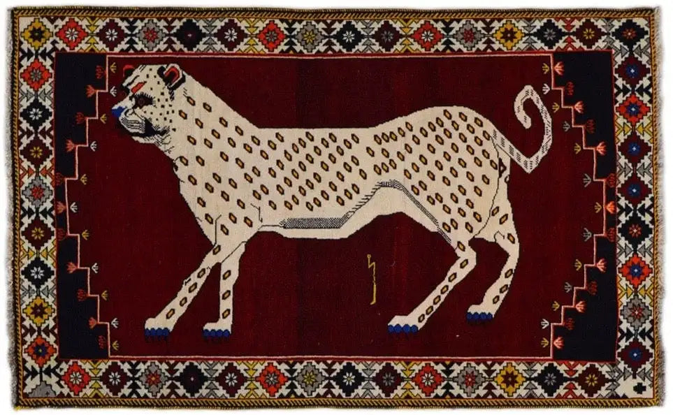 Gabbeh rug with an animal motif in beige on dark red, with a multicolored border design