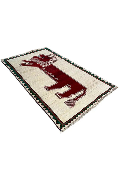 Gabbeh rug with a beige background, red motif, and green decorative border