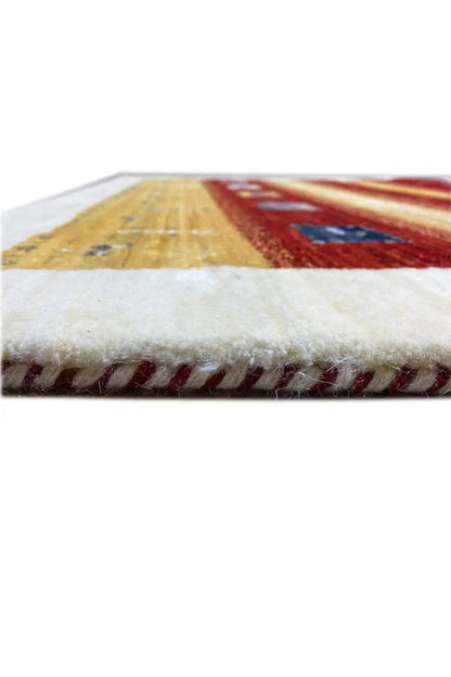 Gabbeh rug 149x99 cm: close-up of the edge with dense red and yellow fringes
