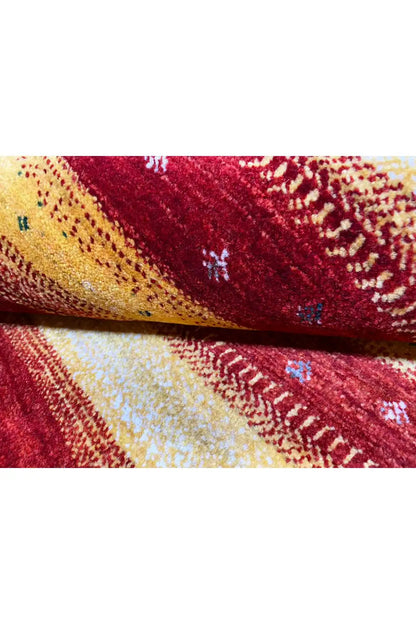 Gabbeh rug 149x99 cm close-up: woven texture in red, yellow, and beige