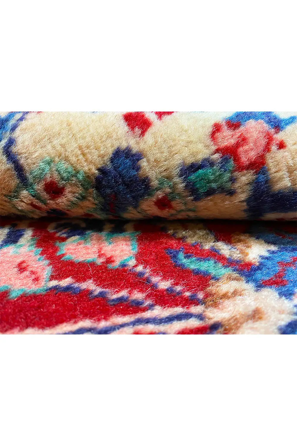 Close-up: woven rug with a red background and multicolored ornaments