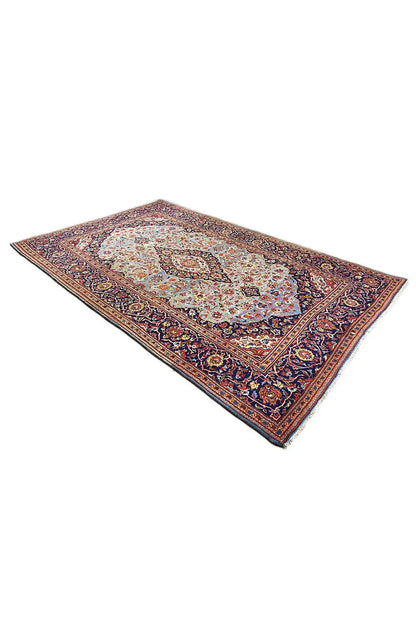 Rug viewed from above at an angle, Oriental pattern with a border in blue, red, and cream