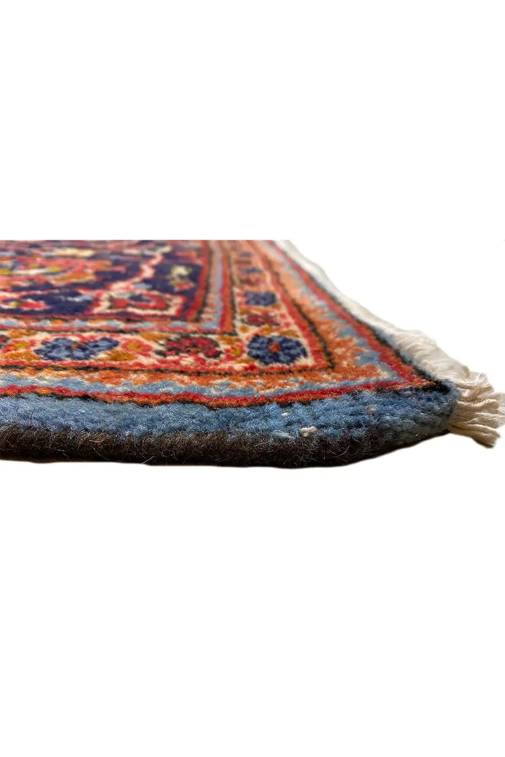 Rug edge with fringe, multicolored pattern in dark blue, red and beige