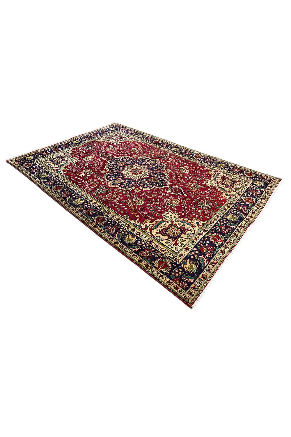 Tabriz rug from an oblique view, red design with a fine blue-and-gold border motif