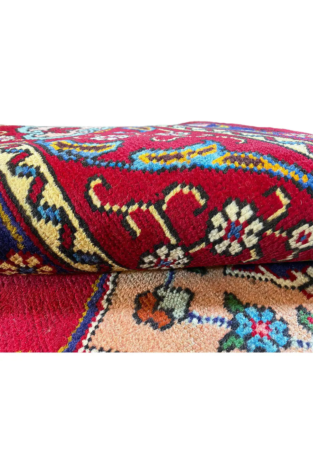 Close-up: red carpet with colorful ornaments, woven pile