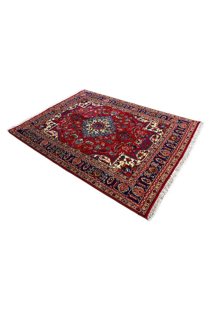 Carpet area with a red central pattern, blue border, and floral ornaments