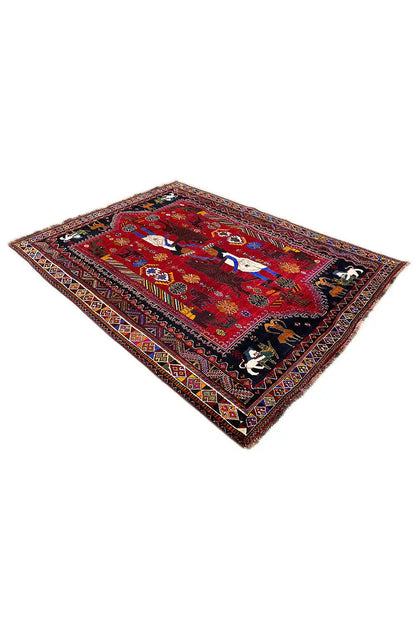 Red Oriental rug with decorative borders and central motifs, laid at an angle