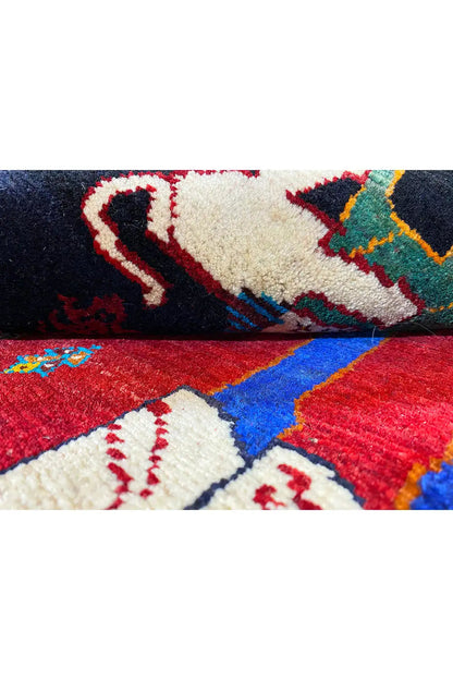 Carpet detail with red pile and multicolored ornaments, white figurative motif