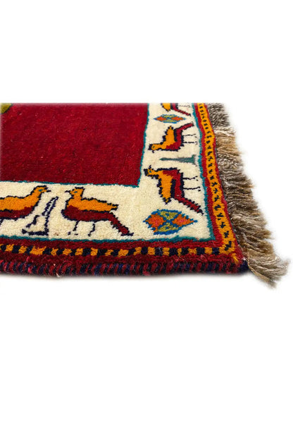 Carpet corner in detail with tassel fringe and blue-red-cream patterned border