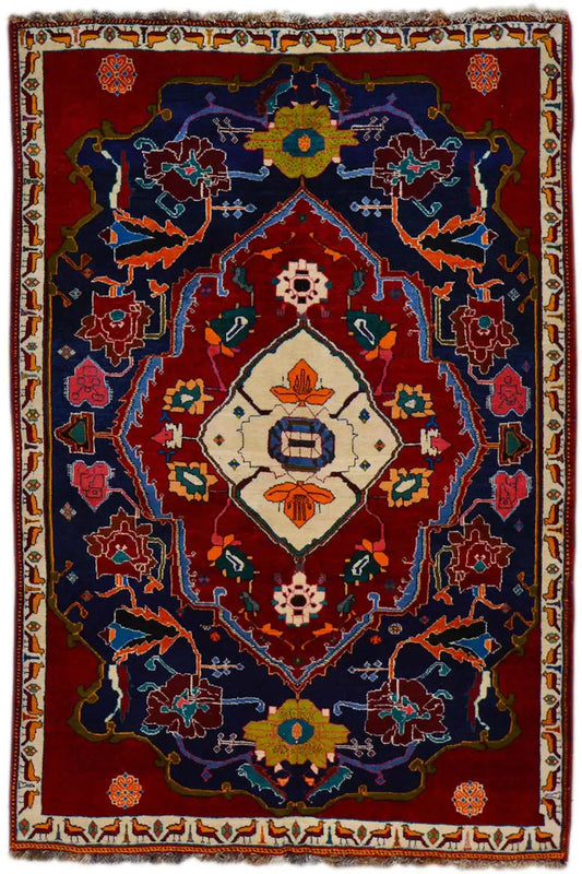 Oriental rug: red border, blue central medallion, ornamental figural patterns
