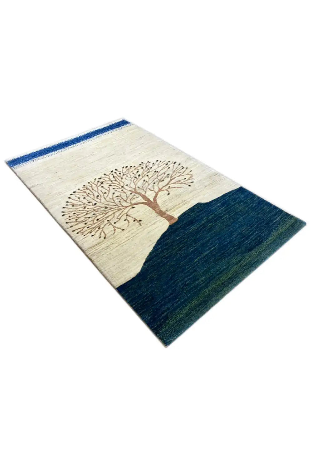 Gabbeh rug in oblique view: brown tree on cream, dark blue wave area, blue border.