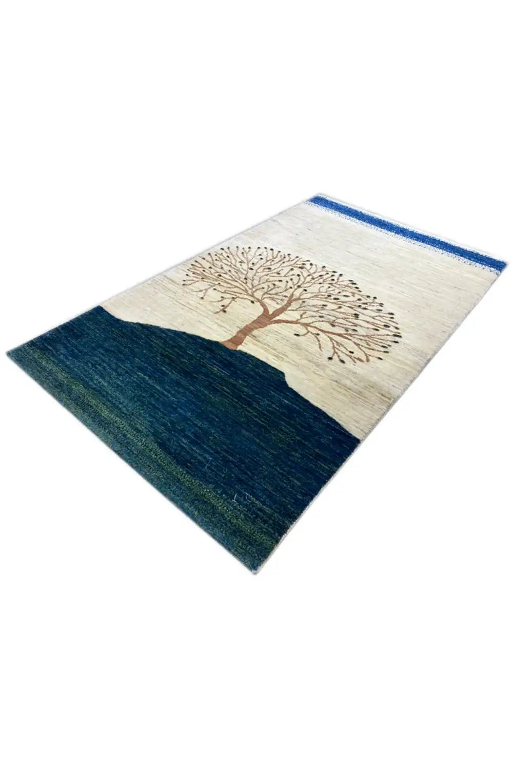Gabbeh rug from an angled perspective: tree motif, cream-colored area, dark blue central field.