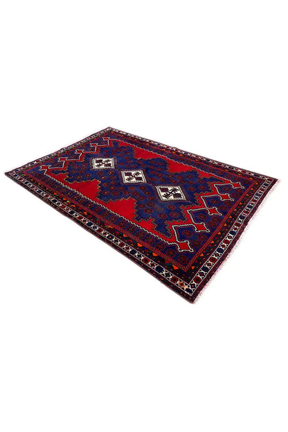 Oriental rug laid at an angle, blue with red sections and a dark border pattern