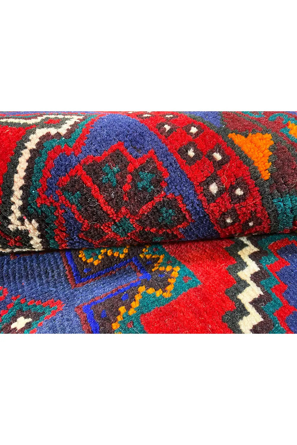 Carpet detail with colorful ornaments, a blue field, and red areas along the hem