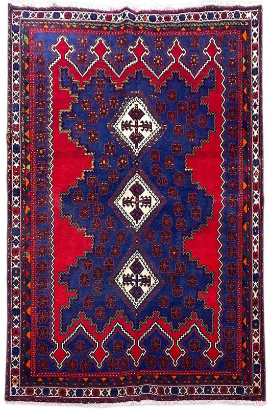 Oriental rug with a blue background, red accents, and a geometric medallion pattern
