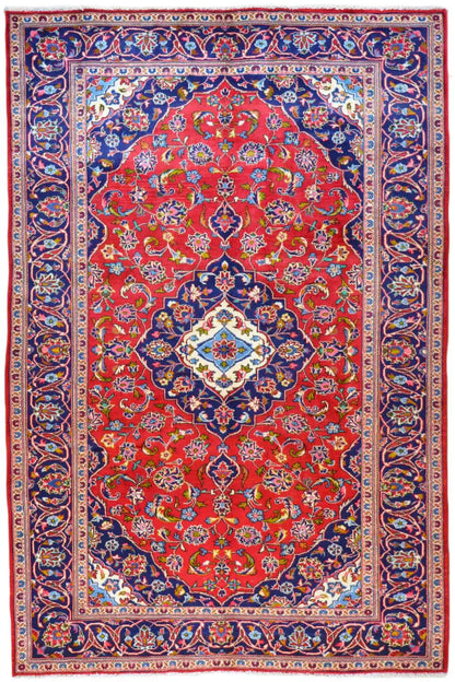 Keshan rug with a red medallion, blue border, and multicolored ornaments, rectangular