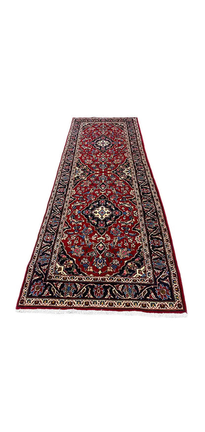 Oriental rug with a red medallion and ornamental border, rectangular.