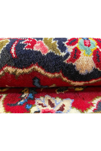 Carpet detail with a colorful pattern and dense pile, with an edge.