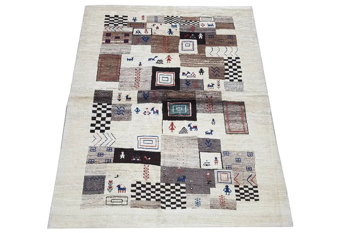 Gabbeh rug with a light background and a patchwork pattern in brown, blue, and black.