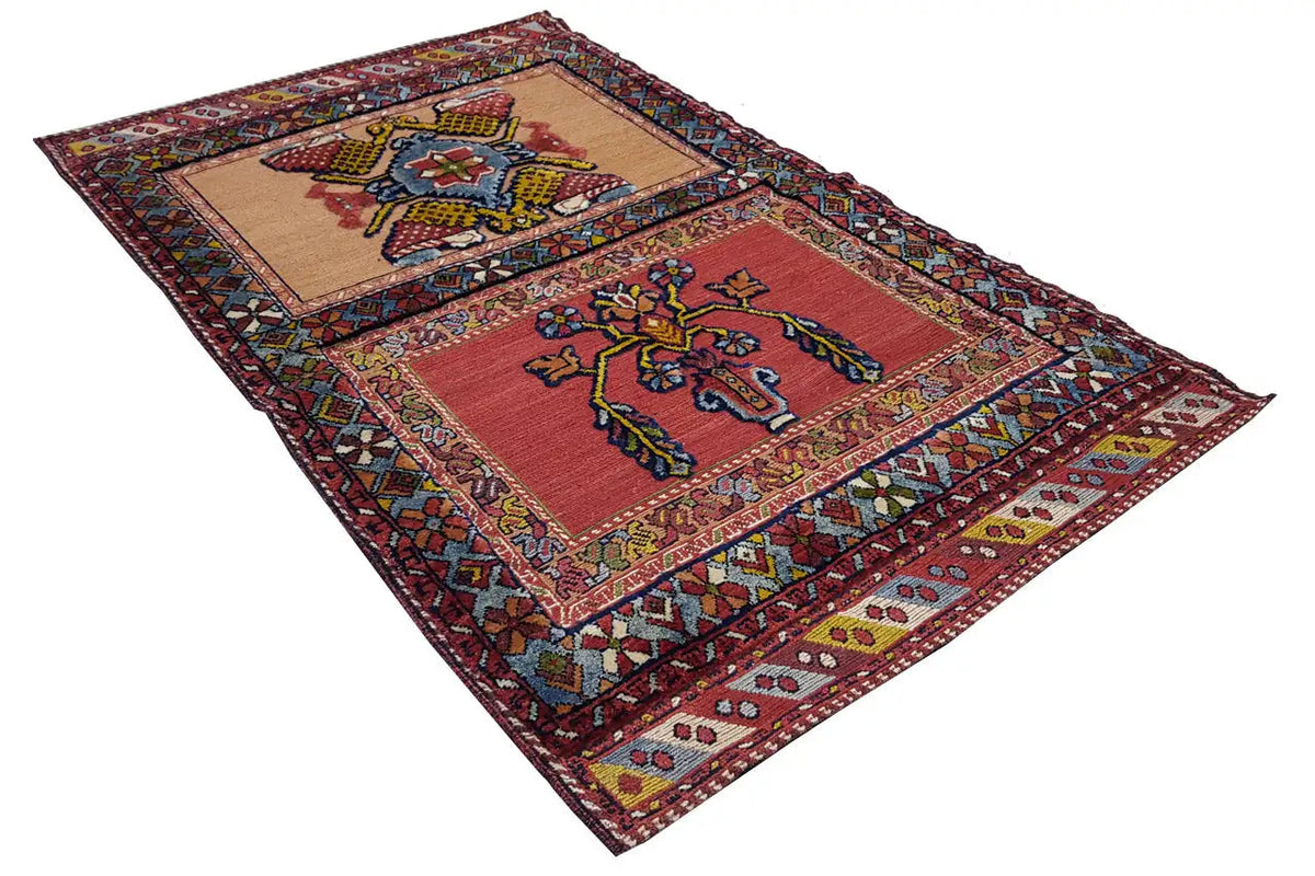 Oriental rug with a red ground and central medallions, multicolored border, approx. 135x83 cm