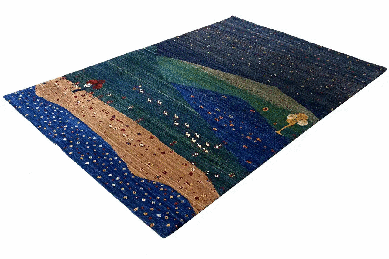 Gabbeh rug with a landscape motif in blue, green, and beige, spread out diagonally