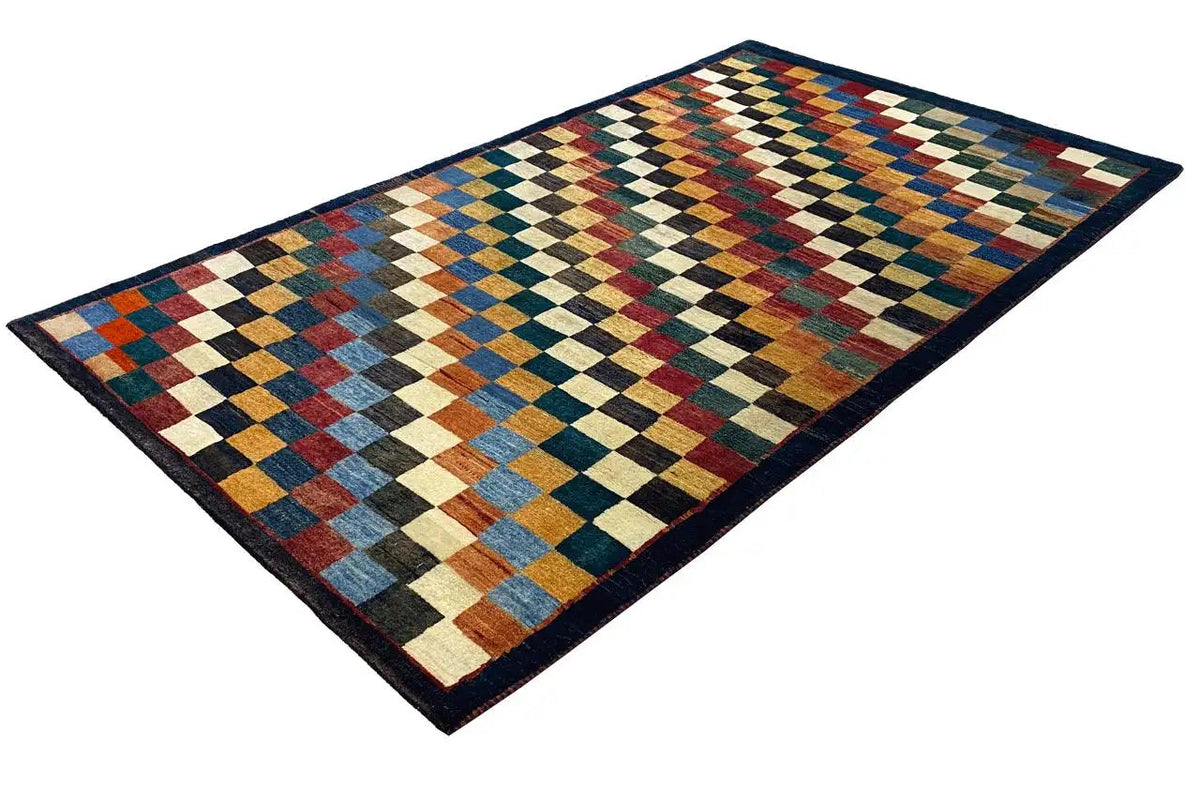 “Lori” Gabbeh rug with a multicolored checkered pattern and dark blue border