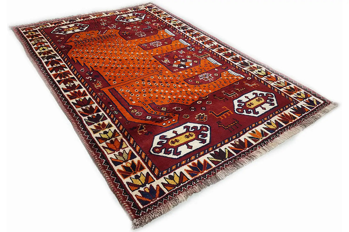 Gabbeh rug with burgundy-orange fields, clear ornaments, corner border, and fringes