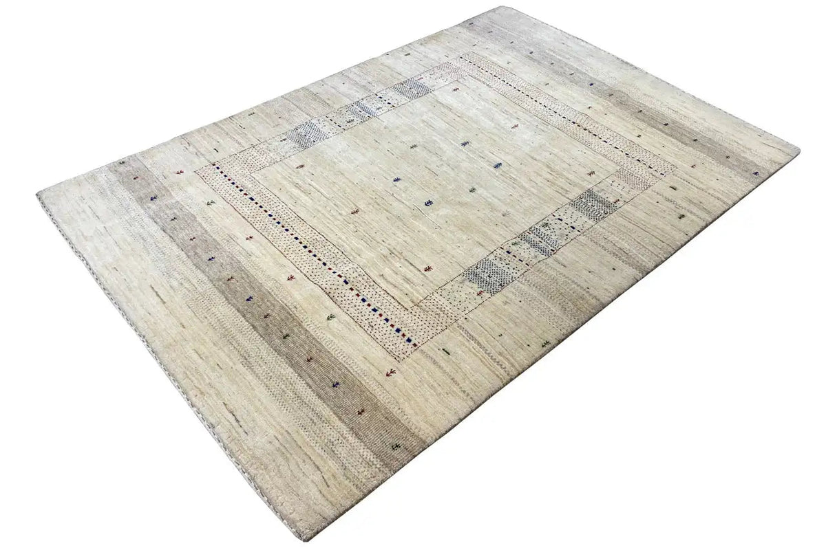 Gabbeh rug with a light beige background, rectangular border design, and colorful dots