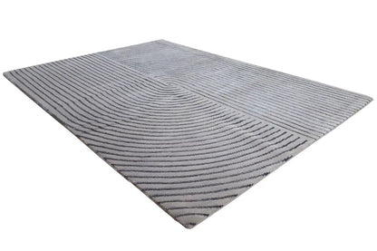 Triangle-shaped rug with a gray background and dark blue wavy lines