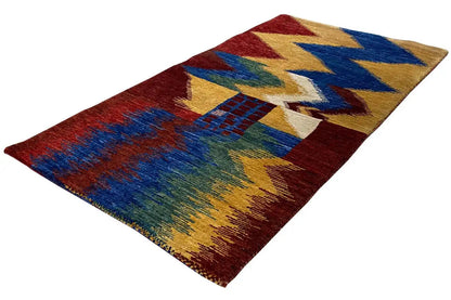 Gabbeh rug with a zigzag pattern in red, blue, yellow and green