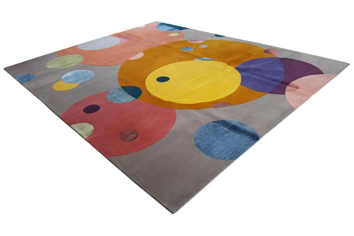 Rug with large colorful circles and dots on a gray background