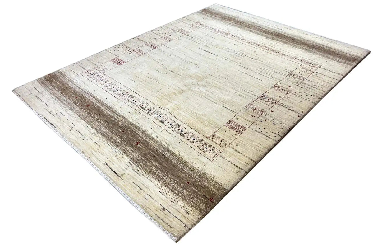 Lori Gabbeh rug, light beige with a brown border and fine red/ blue patterns