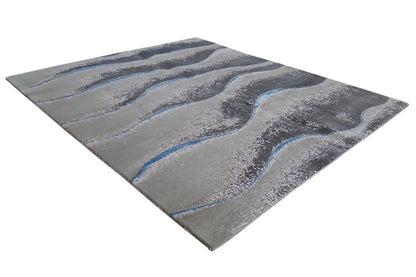 Beach rug 154x183 cm with an abstract wave pattern in gray and blue.