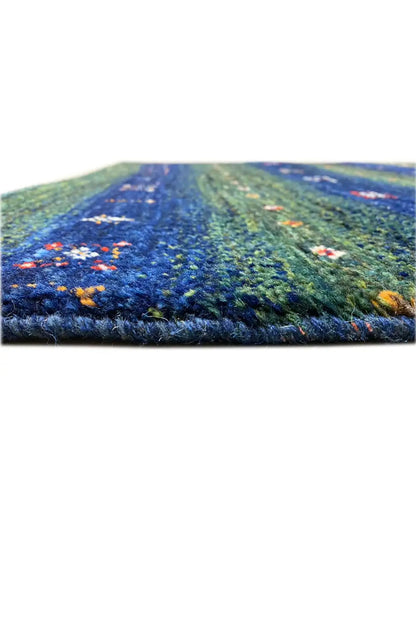 Gabbeh rug 128x81 cm, side close-up of the pile height, green-blue with stripes