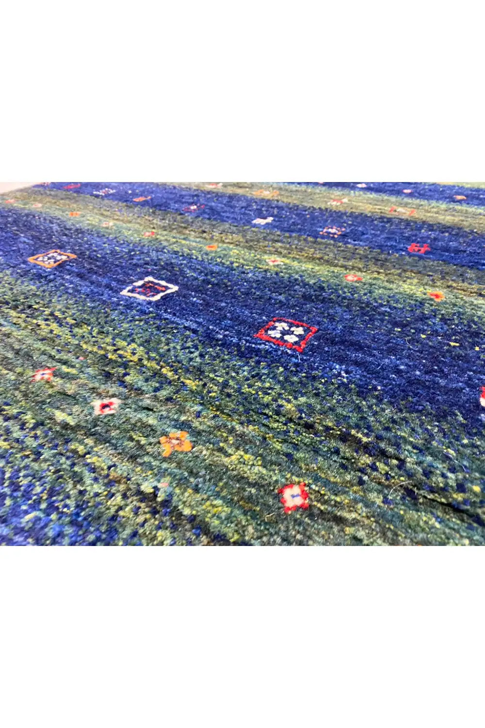 Gabbeh rug 128x81 cm, close-up of the woven structure with a green-blue pattern