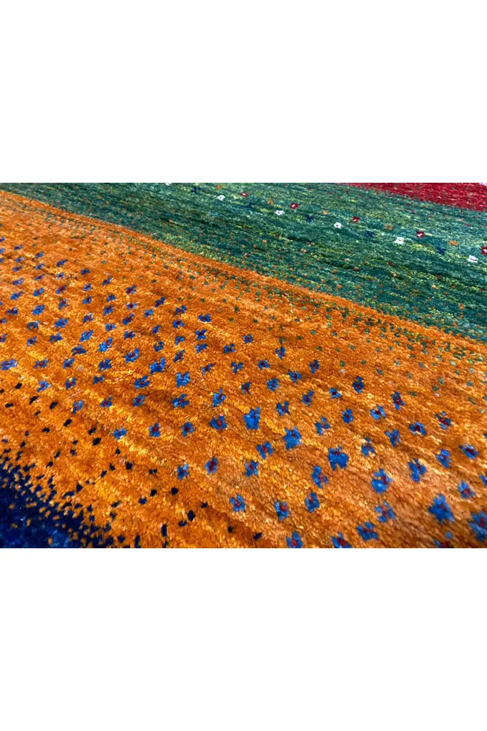 Close-up of a Gabbeh rug, orange section with blue and green threads