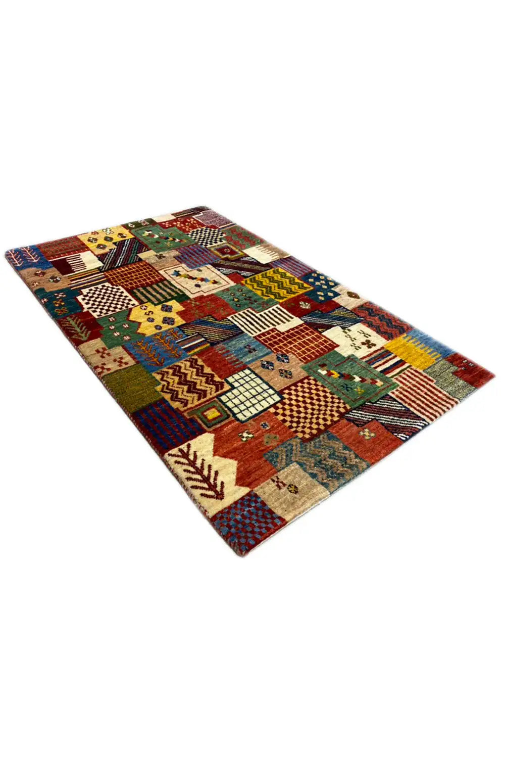 Gabbeh rug 129x80 cm, photographed at an angle with a high-contrast patchwork design
