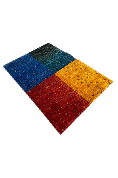 Gabbeh rug, folded in a diagonal view: yellow, blue, red, and green with speckles