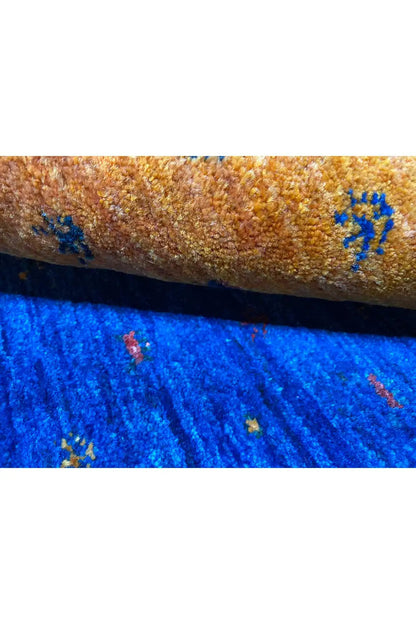 Gabbeh rug close-up of the selvedge: yellow and blue with colorful knot points