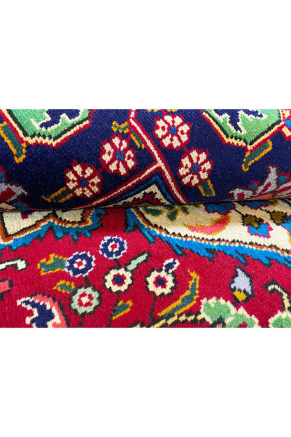 Carpet detail: multicolored ornamental stripes on a red background