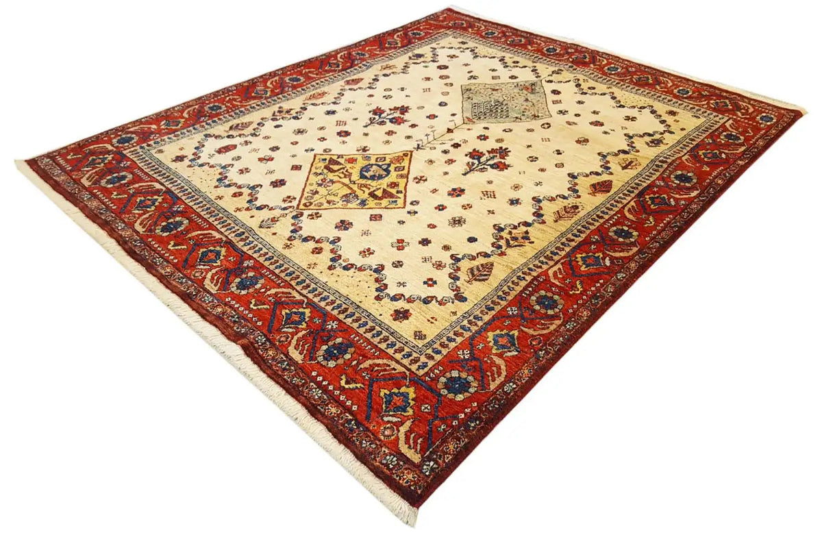 Oriental rug with a cream-colored background, red border, and geometric medallion