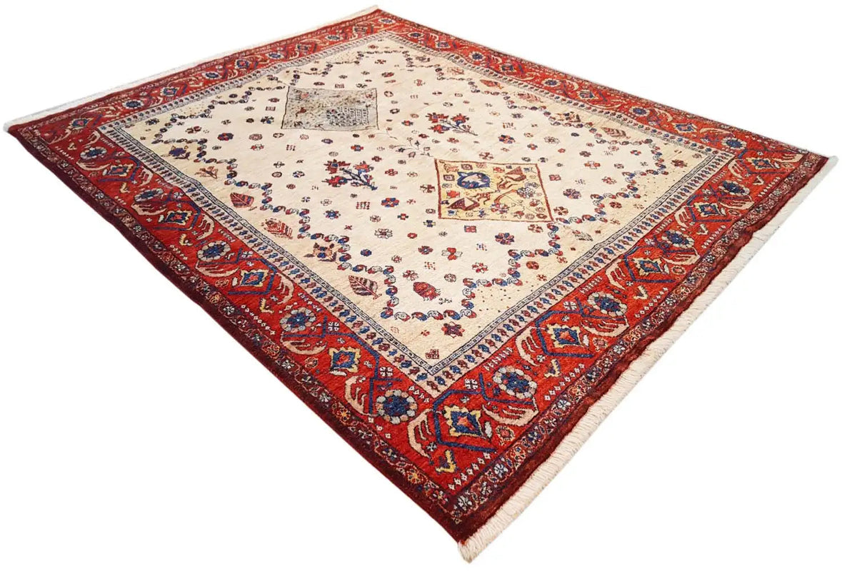 Oriental rug with a cream-colored base, red border, and central decorative medallion