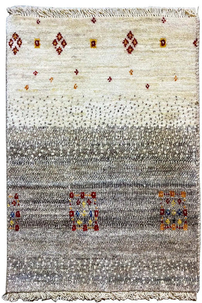 Gabbeh rug front view: light background, gray area with colorful squares and fringes