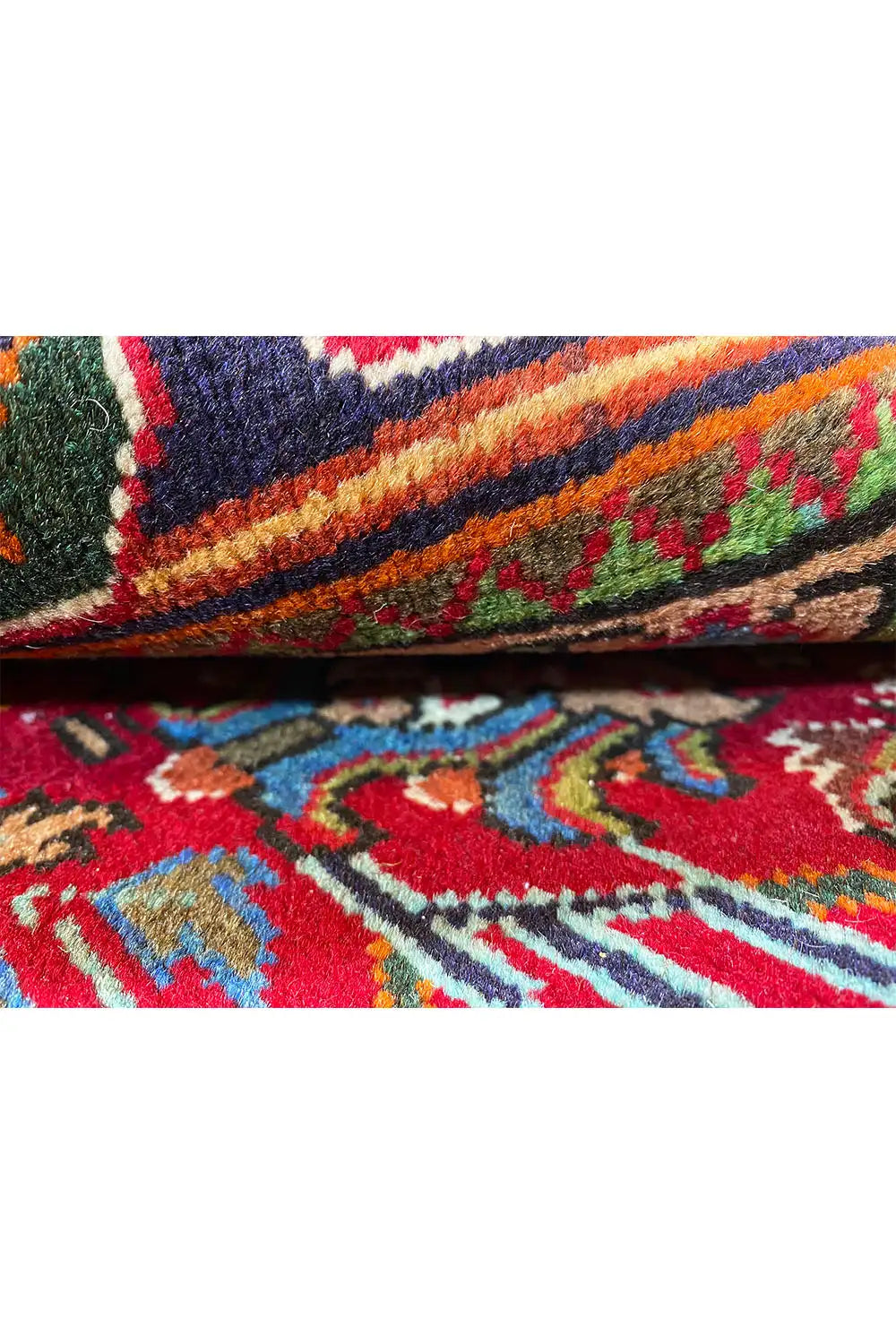Close-up of a carpet edge with a multicolored ornamental pattern and dense pile